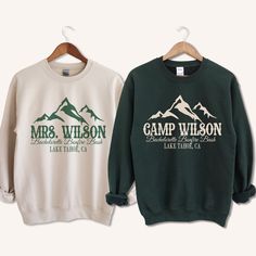 two sweatshirts with the words camp wilson on them