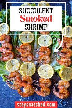 shrimp skewers with lemons and lettuce on a blue counter top