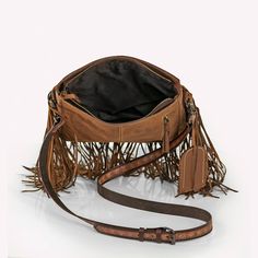 Sun Dance Leather Fringe Crossbody Bag Embrace the spirit of the Wild West with our Sun Dance Leather Fringe Crossbody Bag, where timeless style meets rugged charm. This exquisite bag features a vibrant mix of cowhide and intricate geometric patterns, perfect for those who appreciate unique fashion statements. Compact yet remarkably spacious, this bag is designed for functionality and flair. It's crafted from premium materials that promise durability, ensuring it can withstand the adventures of Leather Bag With Removable Pouch For Festivals, Western Style Bags For Festivals, Leather Hobo Bag Crossbody For Festival, Leather Crossbody Hobo Bag For Festivals, Leather Satchel Saddle Bag For Festivals, Western Style Leather Shoulder Bag For Everyday Use, Western Style Saddle Bags For Everyday Use, Leather Crossbody Shoulder Bag For Festivals, Leather Crossbody Satchel For Festival