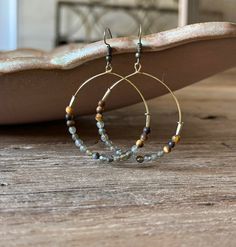 Earthy tiger’s eye combines with iridescent labradorite for a versatile statement hoop to elevate your everyday to pm looks. Warm and neutral stone hues to pair with endless looks and various necklace designs. -1.5” hoops Neutral Stone, Necklace Designs, Labradorite, Hoop Earrings, Stone, Design