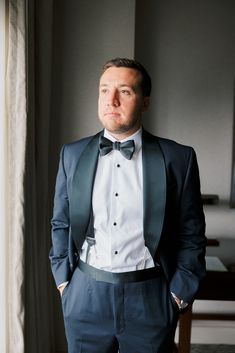 a man wearing a suit and bow tie