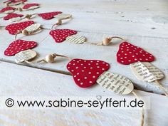 red and white polka dot heart garland with music notes on it, sitting on an old wooden table