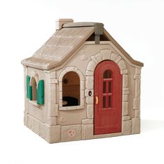 a toy house with a red door and green shutters