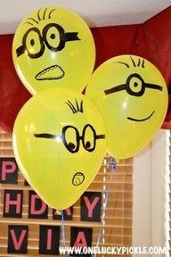 three yellow balloons with faces drawn on them