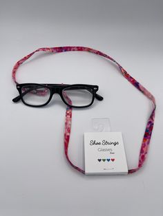 "B. Odd💜B. Bold💚B. Unique💙B. You❤️B. Happy Shoe Strings Glasses Laces are handmade from cotton fabric in various beautiful prints.  Spice up your eyeglasses with our glasses laces and show the world your own unique style! Each of our Glasses Laces have adjustable silicon rings that just slip into your glasses and fit all sorts of, reading glasses, prescription glasses and sunglasses.  Each lace is approximately 30\" in length.  PLEASE NOTE:  Laces are cut from the same fabric as pictured, but Trendy Adjustable Glasses Chains For Everyday Use, Handmade Adjustable Pink Glasses Chains, Adjustable Pink Glasses Chains As Gift, Adjustable Pink Glass Glasses Chains, Trendy Pink Glasses Chains For Gifts, Silicon Rings, Glasses Prescription, Happy Shoes, Glasses Chains