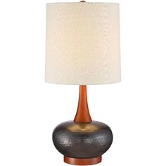 a table lamp with a white shade on the base and a brown vase underneath it