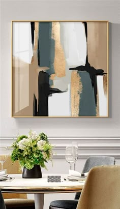 an abstract painting hangs above a dining room table