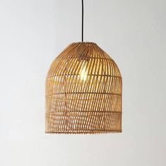 a light that is hanging from the ceiling with a rattan pattern on it and a black cord