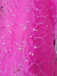 a pink dress with silver sequins on it