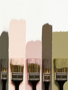 three paintbrushes with different shades of pink and grey on them, one is black