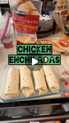 chicken enchiladas in a glass dish on a counter with the words chicken enchiladas