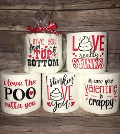 four rolls of toilet paper with valentine's day sayings on them, wrapped in cellophane