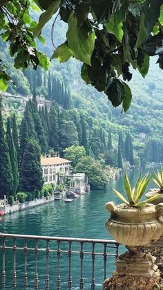 a planter sitting on top of a balcony next to a body of water