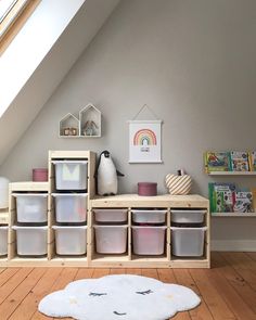 a room filled with lots of toys and storage containers on top of wooden flooring