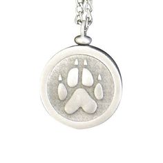 a dog's paw is shown in the center of a silver pendant on a chain