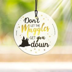 a white ornament with the words don't let the muggles get you down