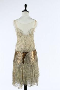 One Item | Kerry Taylor Auctions A Callot Soeurs couture ivory tulle and bronze lame flapper dress, Summer, 1927. the matching oyster pink satin slip with printed gold on ivory silk label 'Callot Soeurs, Paris, Ete 1927, Nouvelle Marque Deposee and indistinctly numbered '96199', the bodice adorned with silver and opalescent sequins, fine gold strip areas to the ground,  - See more at: http://kerrytaylorauctions.com/one-item/?id=48auctionid=401#sthash.jhW56mES.dpuf Wings Dress, Velvet Gown, Ivory Silk