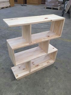 a wooden shelf sitting on top of a cement floor