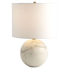 a white marble ball lamp with a beige linen shade on the bottom and a gold metal base