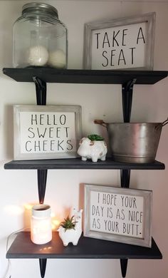 three shelves with signs and candles on them