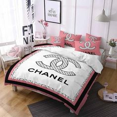 a chanel bed set with pink and black accents on the comforter is shown