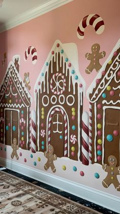 the wall is painted with gingerbread houses and candy canes on it, along with other gingerbread decorations