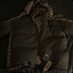 This Is A Steal . Brand New Reversable Medium Official Never Worn Fendi Down Jacket . Original Price $3,590 Don’t Miss Out. This Was A Gift But I Already Got The Same Exact Jacket Already So I’m Selling This Cheaper Just To Get Something Off Of It. No Need To Have 2 Of The Same Jackets. $900 Or Best Offer. Zelle , Cash App , Apple Pay Or Pay In Person Or Through Poshmark ..To Many People Have Been Contacting Me To Scam Me For My Products. Please Don’t Waste Your Time. I’m Onto All The Games And Designer Outerwear With Padded Collar For Streetwear, Designer Black Winter Outerwear, Winter Outerwear With Logo-jacquard Lining And Long Sleeves, Designer Black Puffer Outerwear, Fall Outerwear With Logo-jacquard Lining And Long Sleeves, Designer Brown Winter Outerwear, Designer Winter Streetwear Outerwear, Fall Long Sleeve Outerwear With Logo-jacquard Lining, Luxury Outerwear With Pockets For Streetwear