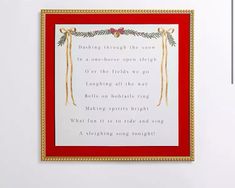 a framed poem hanging on the wall in front of a red frame with gold trim