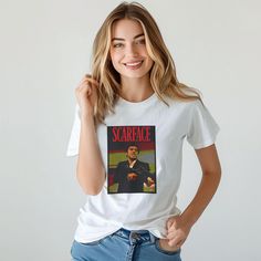 a woman wearing a t - shirt that reads scarfface