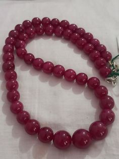 Ruby Necklace Natural Ruby Corundum Smooth Round Beads 501 Carat Ruby Necklace 1.Ruby Corundum 2. Ruby Round Beads 3. 18 inches length, 1 Line String 4. 501 -carat weight 5. 12x12 - 9x9 mm stone size Polish :- Handmade Purity :- AAA These natural Ruby gemstones can be used to make different jewellery items like earrings, bracelets and others. They have a great shine to them and makes a great gift for your loved ones. Click below to see live stock: https://www.etsy.com/au/shop/ShakugemsStore?ref= Polished Beads For Formal Gems And Cabochons, Elegant 8mm Round Beads For Jewelry Making, Formal Ruby Necklaces With Round Beads, Classic Necklace With Large Beads For Gift, Classic Round Polished Beaded Necklaces, Luxury Necklaces With Gemstone Round Beads, Classic Round Beaded Necklace With Polished Beads, Classic Polished Beaded Necklace, Formal Round Beaded Necklace With Large Beads