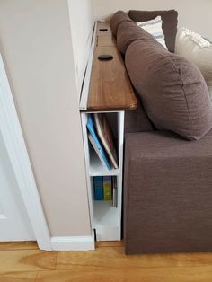 a brown couch sitting next to a wooden table