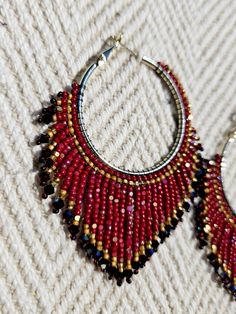 Colors - Dark red / Retro Gold Unique Handwoven Beaded Hoop Earrings with Swarovski Crystals - These elegant 35mm thick coated gold plated (nickel & lead free) hoop earrings are a true statement piece, handwoven with two-sided cut Charlotte beads that shimmer from every angle. The design is elevated with sparkling Swarovski bicone stones, creating a luxurious and eye-catching finish. Measuring 2.76 inches in length and 2.35 inches in width, these earrings are perfect for making a bold and elegant impression. They are a stunning addition to any jewelry collection. Due to their intricate craftsmanship, please handle them with care to maintain their beauty. * Please note that colors may vary slightly due to different monitor settings. Fringe Hoop Earrings, Red Retro, Beaded Hoop Earrings, Jewelry Earrings Hoops, Aurora Borealis, Beading Patterns, Dark Red, Beaded Earrings, Halloween Shopping