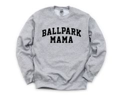 W H A T ' S * I N C L U D E D A super soft, sport gray sweatshirt with the Ballpark Mama design in black or white. M A T E R I A L S - 50% cotton, 50% polyester - Ribbed collar, cuffs and waistband with spandex - High quality heat transfer vinyl S I Z I N G - Unisex sizes.   - Please refer to the size chart in the listing pictures for more information. C A R E   - Machine wash warm or cold / mild detergent. - Tumble dry low or hang to dry. - Do not use bleach or iron on the design. P R O D U C T I O N * & * S H I P P I N G - Please allow 3-5 business days for production. - Please allow an additional 2-5 business days for your shirt to arrive once it has shipped via USPS or UPS. P L E A S E * N O T E - Shirt colors may vary slightly due to lighting and monitor settings. - Display items in l Game Day Gray Letter Print Sweatshirt, Gray Letter Print Sweatshirt For Game Day, Gray Letter Print Sweatshirt For Fan Gear, Sporty Gray Sweatshirt With Text Print, Gray Team Spirit Sweatshirt For Sports, Collegiate Gray Sweatshirt For Sports, Gray Letter Print Sweatshirt For Sports Season, Gray Sweatshirt With Letter Print For Sports Season, Gray Sweatshirt For Sports Events