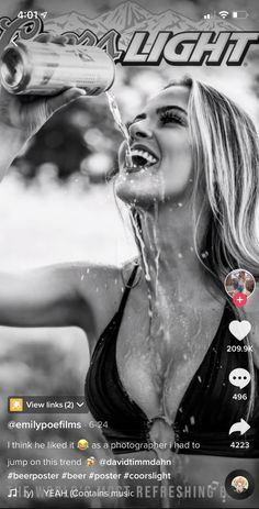 a woman drinking water from a bottle while standing in front of a screen with the caption