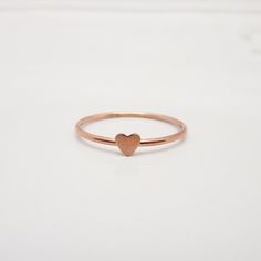 REAL ROSE GOLD FILLED 14/20 I love how this adorable little heart ring turned out and am so happy to share it with you! The dainty band features a polished surface, accented with a tiny heart that measures approximately 3-4 mm. The lovely rose gold color is perfect for this minimalist piece. Great for stacking up with other rings but also beautiful when worn alone. STERLING SILVER, GOLD, OR ROSE GOLD: This listing is for a ring in rose gold filled. However, I can also make these in yellow gold f Stackable Birthstone Rings, Dainty Band, Mom Ring, Real Rose, Gold Alloys, Ring Rose Gold, Tiny Heart, Ring Dainty, Rose Gold Color