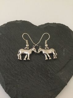 Cute donkey earrings . 19x17mm  adorable zinc alloy donkeys fitted with 20mm surgical steel hypoallergenic fish hook earring wires . Lead and nickel free . These sweet earrings will make a very special gift for any animal loving lady or a wonderful treat for yourself . Matching necklace available . Shipped in a pretty satin gift bag . Estimated shipping times - Business days : North America 5-15 Europe 5-15 Australia / New Zealand  7-21 United Kingdom  1-3 Please note that due to brexit, some overseas orders are subject to customs delays at the destination. Metal Horse Design Jewelry Gift, Cute Donkey, Sweet Earrings, Clip On Charms, Earring Wires, Animal Earrings, Fish Hook Earrings, Matching Necklaces, Animal Jewelry