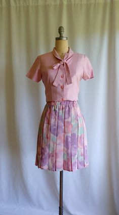 The prettiest 60s vintage skirt in silky pleats A painterly watercolor of pinks, mauves, and aqua shades Wide gathered waistband Exceptional fabric and style Brand: Dorothy Perkins Euro 38 UK 12 US 8 to 10 Measurements: 14 inches across with stretch to 17 inches 21 inches from top of waistband to hem Excellent vintage condition Pink Flowy Pleated Skirt, Flowy Pink Pleated Skirt, Pink Fitted Pleated Skirt Feminine Style, Fitted Pink Pleated Skirt For Spring, Fitted Pink Pleated Feminine Skirt, Fitted Pink Pleated Skirt Feminine Style, Fitted Feminine Pink Pleated Skirt, Vintage Pleated Lined Skirt For Spring, Spring Pink Skirt With Pleated Waist