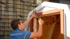 a man working on the side of a building