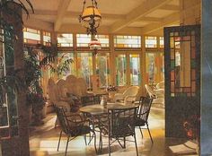 a dining room with lots of windows and chairs