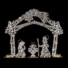 an image of a nativity scene with the baby jesus surrounded by angels in gold and crystal