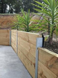 a wooden fence with plants growing in it