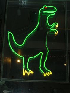 a neon sign with a dinosaur on it