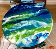 a table painted with blue, green and white swirls