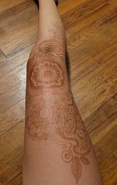 a person with henna on their arm and foot