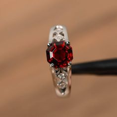 It is a natural garnet ring, octagon cut, measures 7mm*7mm, weight about 2.48 cts. The basic metal is sterling silver and plated with rhodium.To change the metal to a solid gold (white/rose) or platinum is also available, please ask for a quotation if you want.You can also go to my shop Home for more elegant rings: https://www.etsy.com/shop/godjewelry?ref=hdr_shop_menuGarnet is birthstone of January.More Garnet rings:https://www.etsy.com/shop/godjewelry?ref=seller-platform-mcnav&section_id=2 White Gold Garnet Jewelry For Promise Ring, White Gold Garnet Birthstone Promise Ring, Garnet Birthstone Ring In White Gold For Promise, Silver Garnet Birthstone Ring With Center Stone, Red Asscher Cut Diamond Jewelry, Elegant Asscher Cut Birthstone Ring, Red Emerald Cut Birthstone Ring, Red Radiant Cut Ring With Center Stone, Emerald Cut Red Birthstone Ring