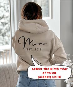 "Mama Sweatshirt, Mum Hoodie, Personalised Mother, Custom Mom Jumper, Mothers Day Gift, Mama Birthday Gift, Mother's Day Top, Mother Gifts, Hooded Sweatshirt, Maternity Gift for Mom, Mom to be Gift Looking for an original birth gift for the brand new mom or a cool Mother's Day gift for the \"experienced\" mom, this personalized hooded sweatshirt with birth year is the solution! 🇺🇸 MADE IN USA FREE SHIPPING USA Available in 5 different colors. This unisex heavy blend hooded sweatshirt is relaxa Birthday Long Sleeve Hoodie With Letter Print, Birthday Letter Print Long Sleeve Hoodie, Long Sleeve Hoodie With Letter Print For Birthday, Casual Cotton Hoodie For Birthday, Winter Birthday Hoodie With Letter Print, Hooded Letter Print Sweatshirt For Birthday, Hooded Sweatshirt With Letter Print For Birthday, Mother's Day Hooded Hoodie With Letter Print, Winter Birthday Sweatshirt With Letter Print