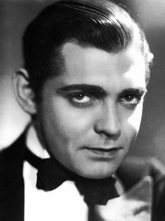 a black and white photo of a man in a tuxedo