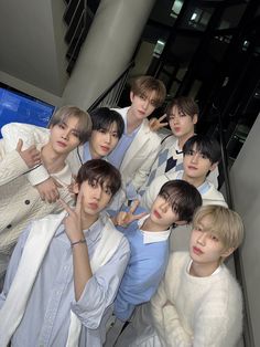 a group of young men standing next to each other in front of a stairwell way