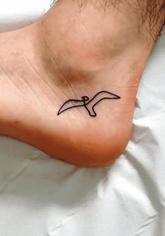 a small tattoo on the foot of a person