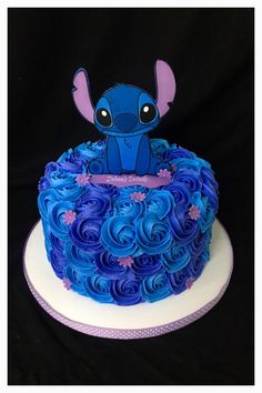 a blue and purple cake with an elephant on top